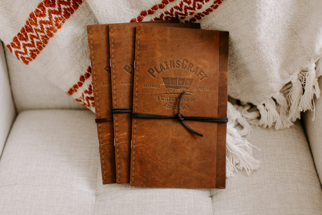 Brochures for PlainsCraft Covered Wagons are sitting on a chair