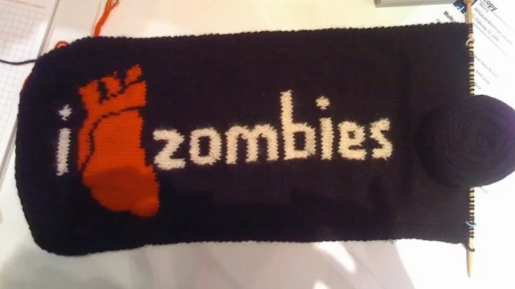 A knitted scarf that says "I heart zombies"
